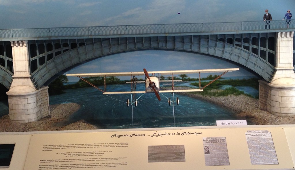 Scaled model of Auguste Maïcon flying his plane under the Nice bridge